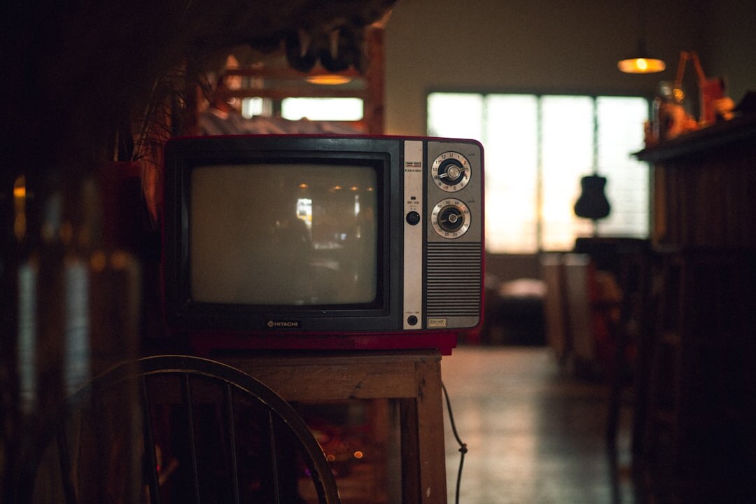 Close-up of a glowing vintage CRT television screen in a dark room